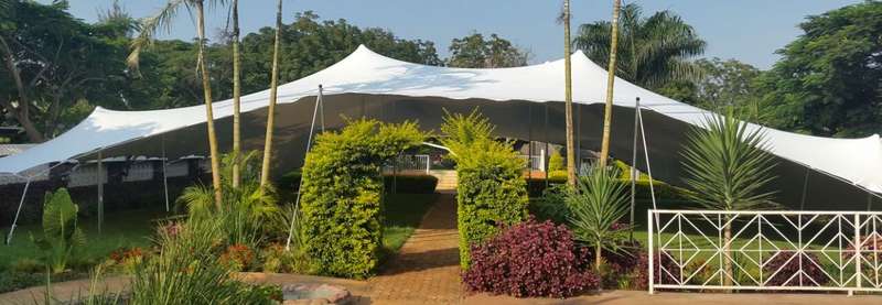 Large white stretch tent hire in tropical garden South Africa